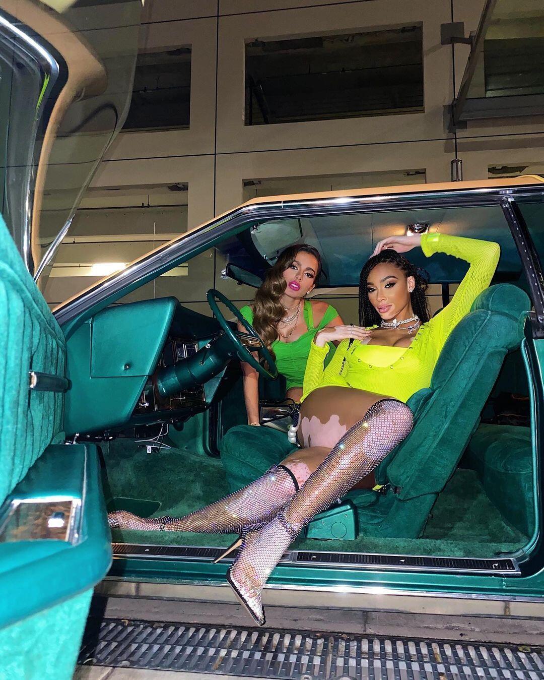 Winnie Harlow posing in a car with friend