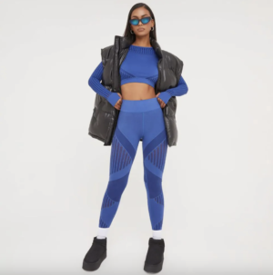 long sleeve blue top with blue leggings and black gilet